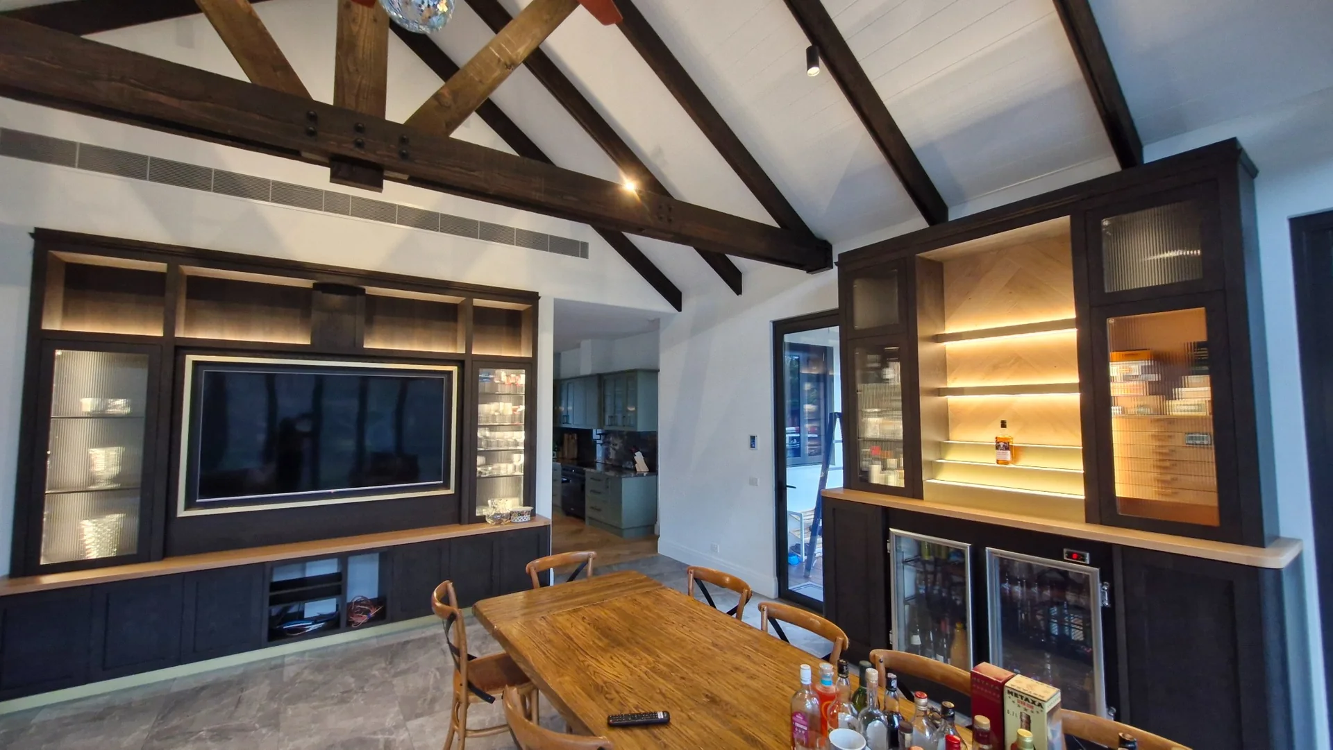 Integrated TV and bar cabinetry lighting, added in July 2026.